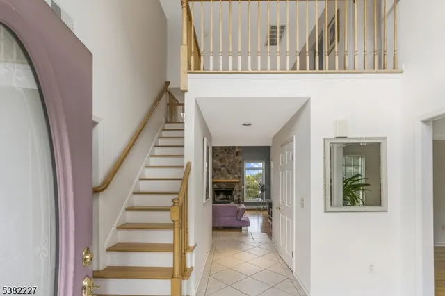 a view of a hallway with wooden floor and entryway