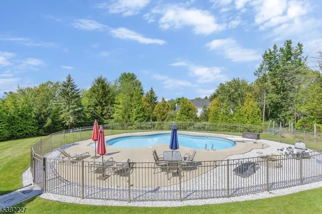 a view of a backyard with swimming pool