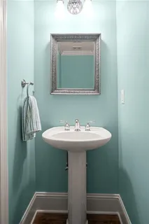 a spacious bathroom with a tub shower and a sink