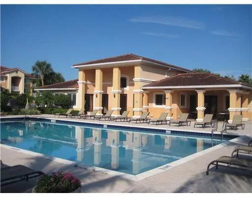 a front view of a house with swimming pool and porch