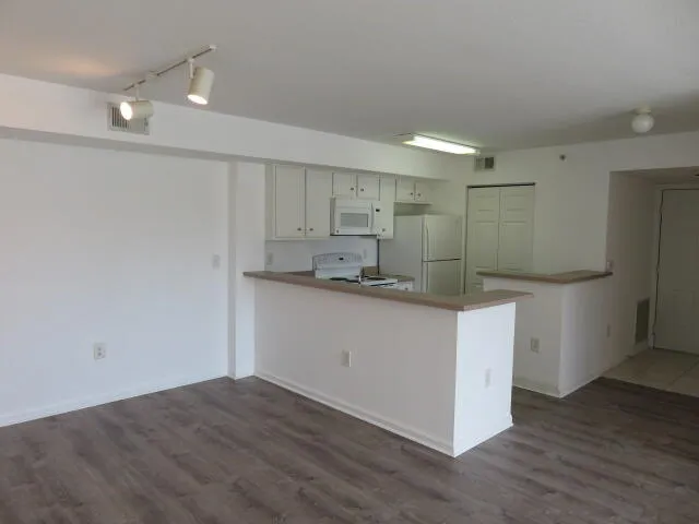 a kitchen with kitchen island cabinets and wooden floor