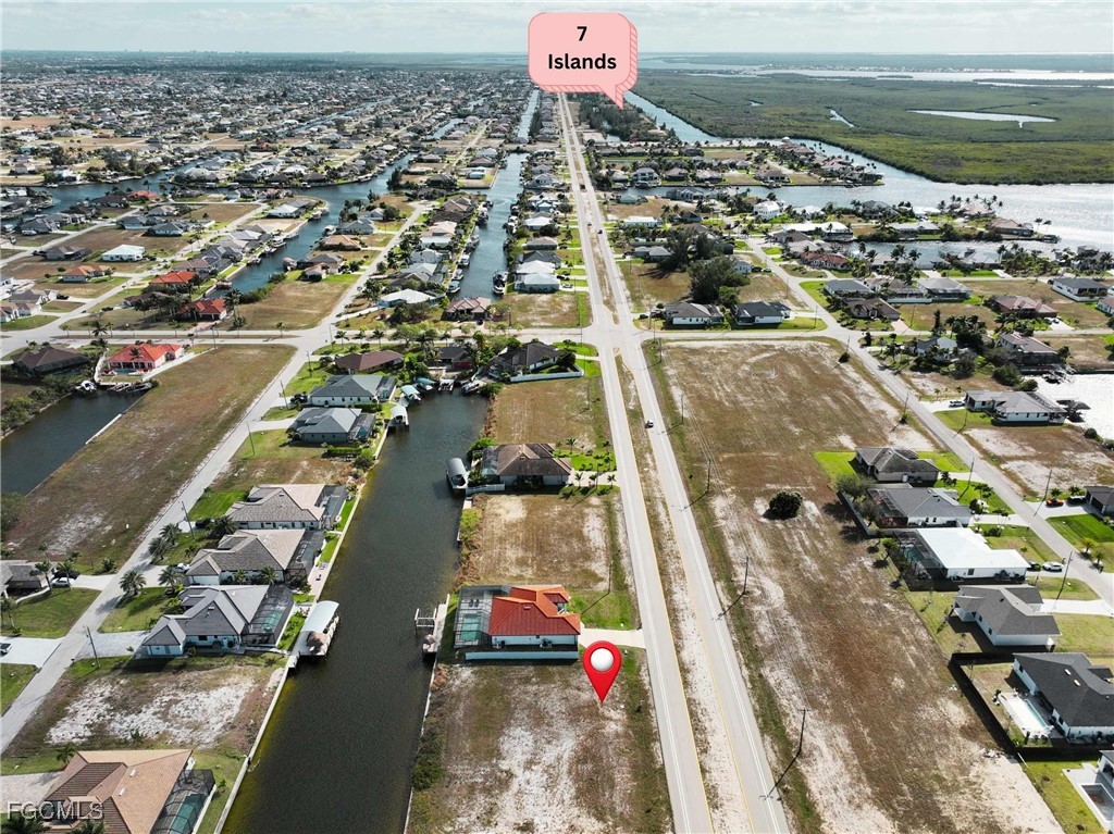 1235 Old Burnt Store Road North Cape Coral, FL 33993 - Photo 3 of 7 an aerial view of residential houses with outdoor space