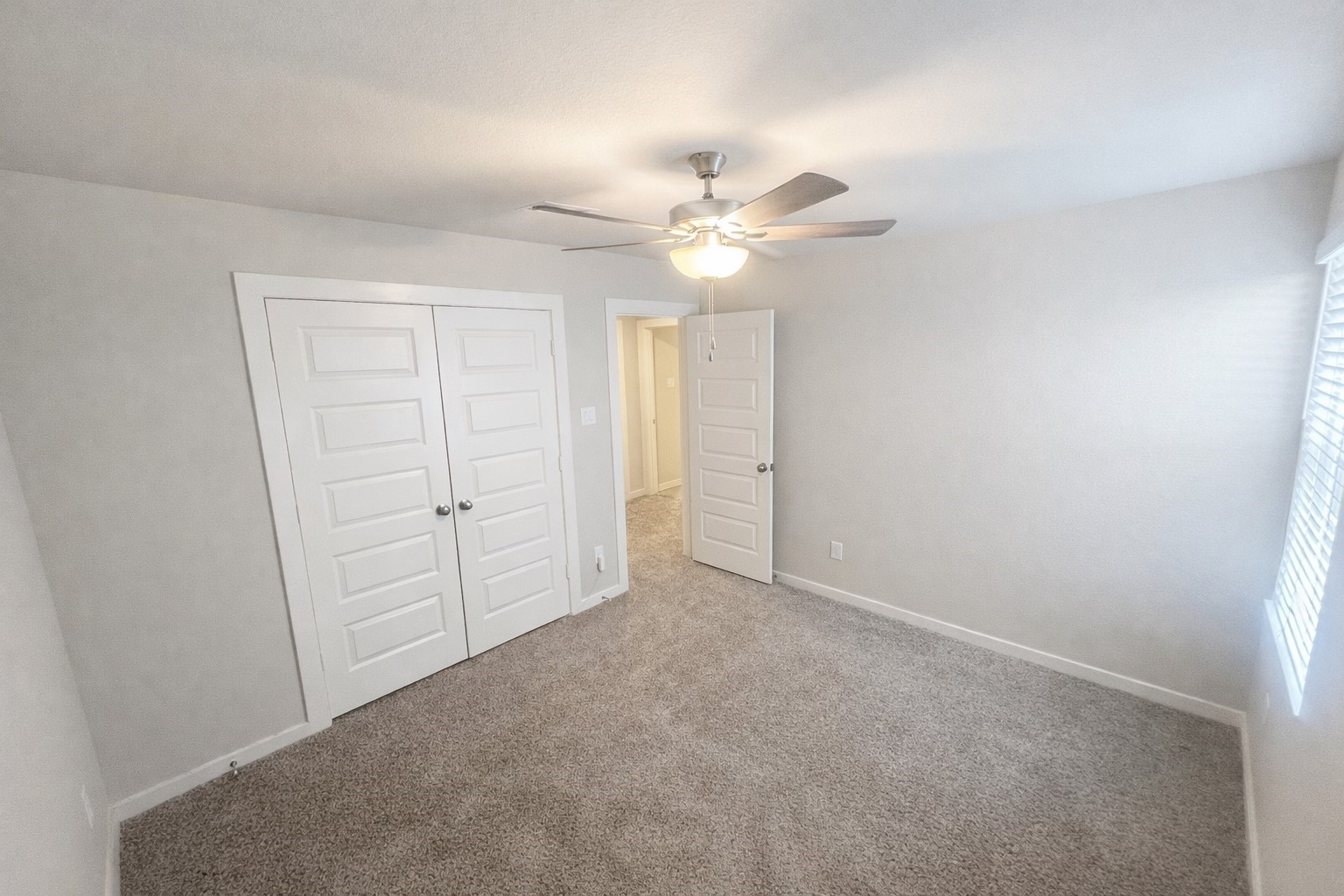 5715 Madden Lane Houston, TX 77048 - Photo 13 of 16 an empty room with a ceiling fan and a window