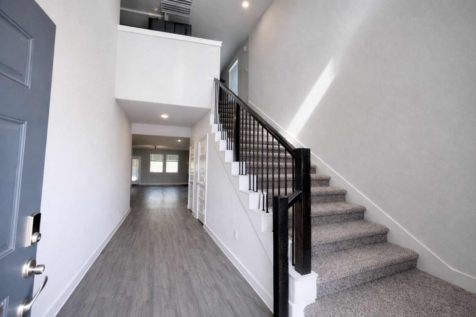 5715 Madden Lane Houston, TX 77048 - Photo 2 of 16 a view of a hallway with wooden floor and staircase