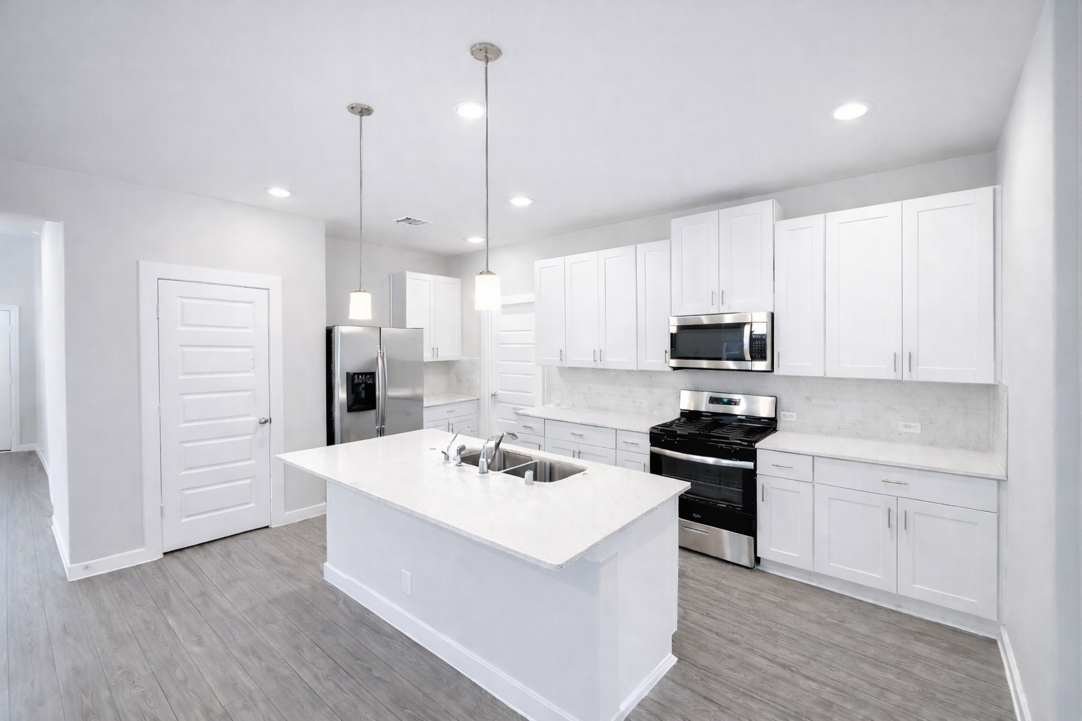 5715 Madden Lane Houston, TX 77048 - Photo 4 of 16 a kitchen with a sink a stove a refrigerator and white cabinets