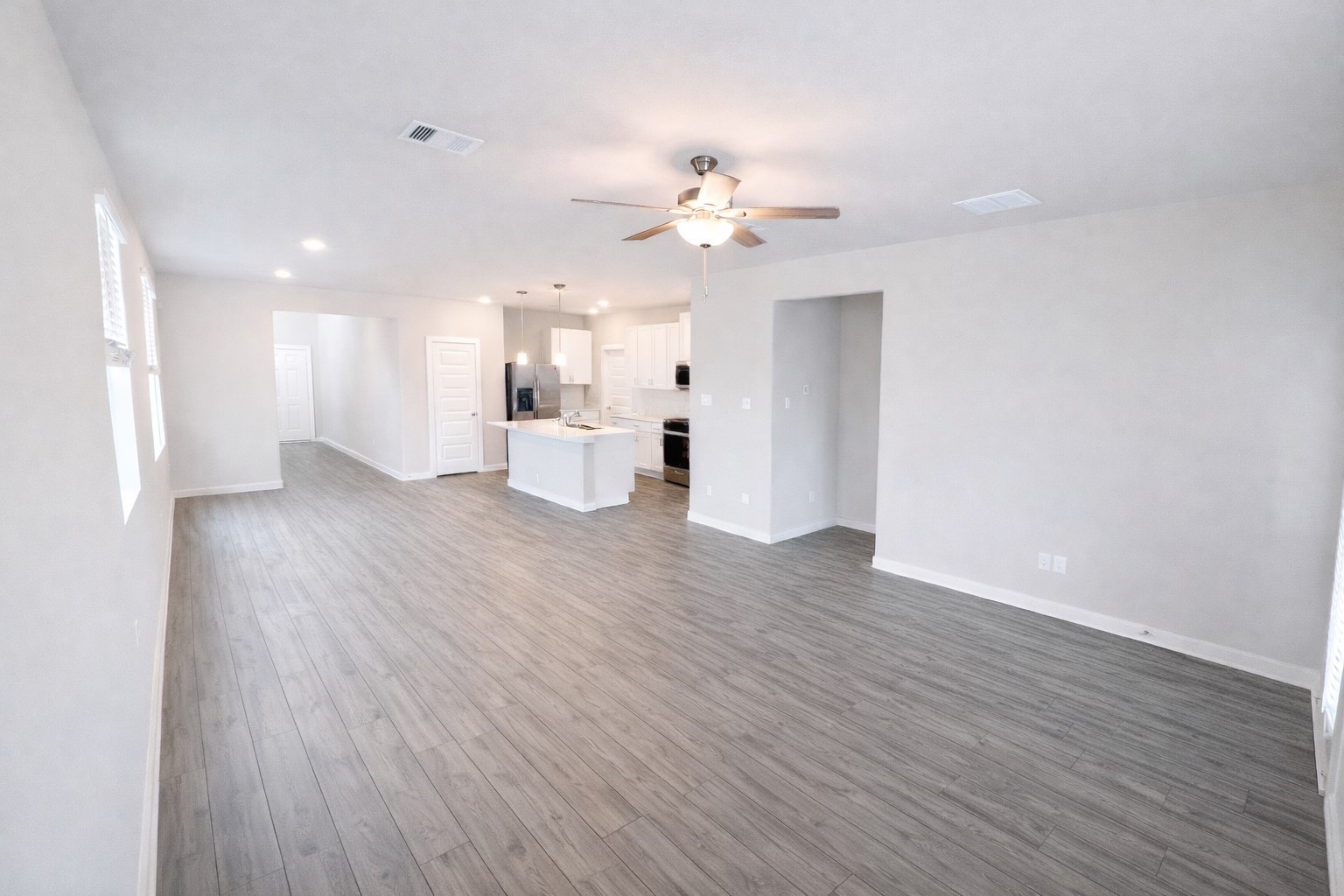 5715 Madden Lane Houston, TX 77048 - Photo 5 of 16 a view of a room with wooden floor and ceiling fan