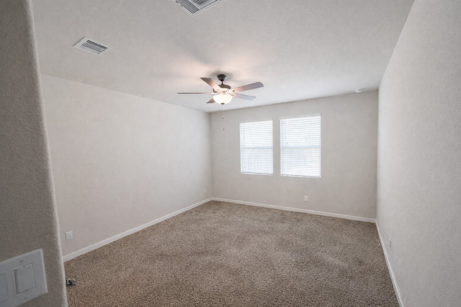 5715 Madden Lane Houston, TX 77048 - Photo 6 of 16 an empty room with windows and ceiling fan