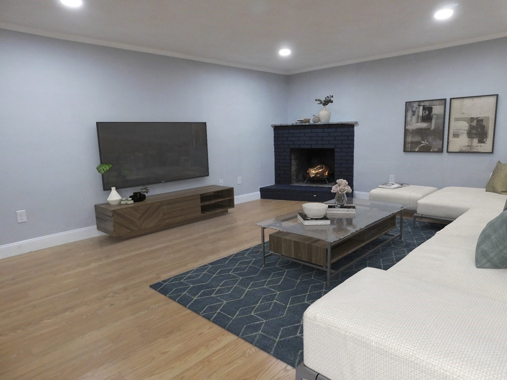 80 Mountain Gate Road, Unit 80 Ashland, MA 01721 - Photo 11 of 42 a living room with furniture and a flat screen tv