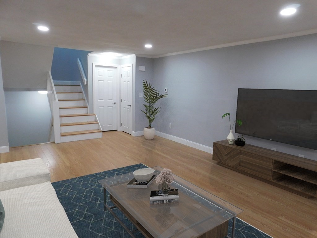 80 Mountain Gate Road, Unit 80 Ashland, MA 01721 - Photo 12 of 42 a living room with furniture and a flat screen tv
