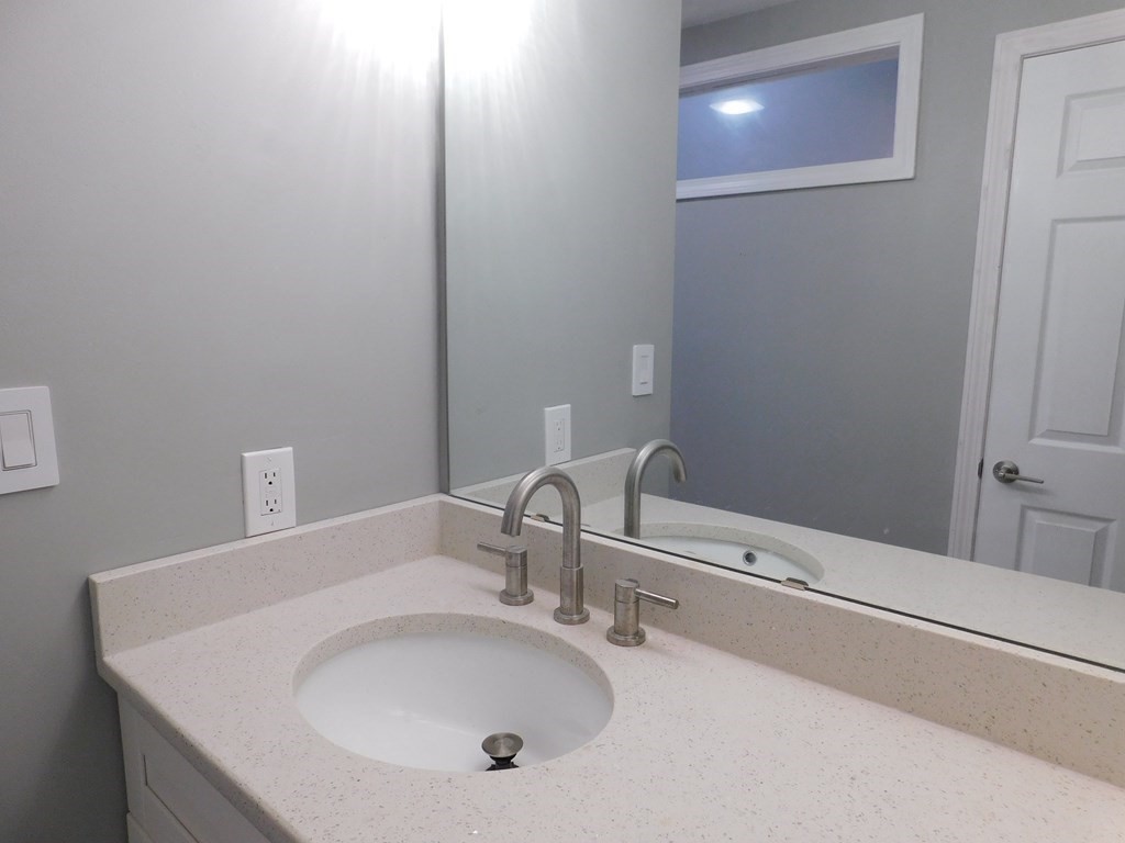 80 Mountain Gate Road, Unit 80 Ashland, MA 01721 - Photo 24 of 42 a bathroom with a sink and a mirror