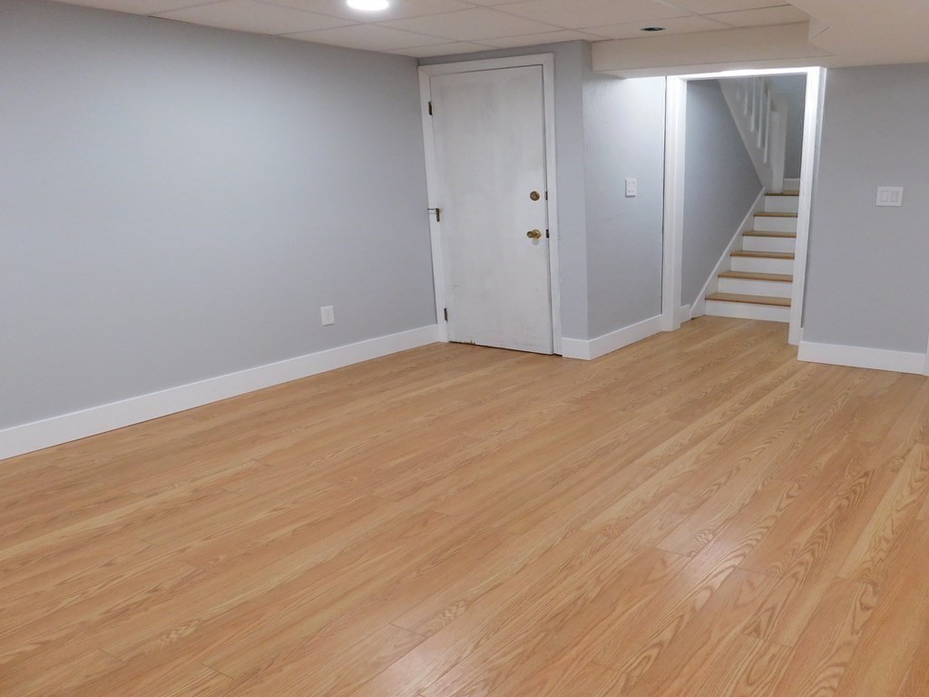 80 Mountain Gate Road, Unit 80 Ashland, MA 01721 - Photo 31 of 42 a view of an empty room with wooden floor