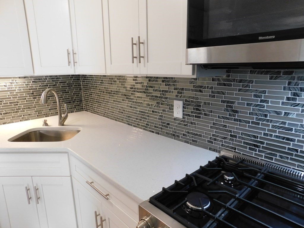80 Mountain Gate Road, Unit 80 Ashland, MA 01721 - Photo 5 of 42 a kitchen with a sink and cabinets