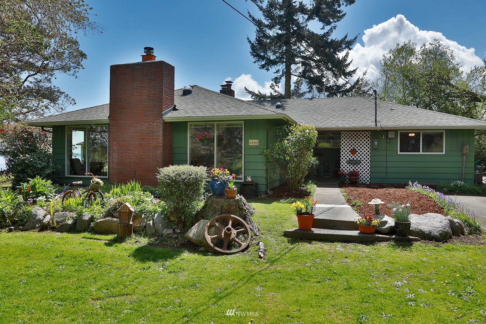 1294 Bonnie View Acres Road Oak Harbor, WA 98277 - Photo 2 of 39 a front view of a house with garden and porch