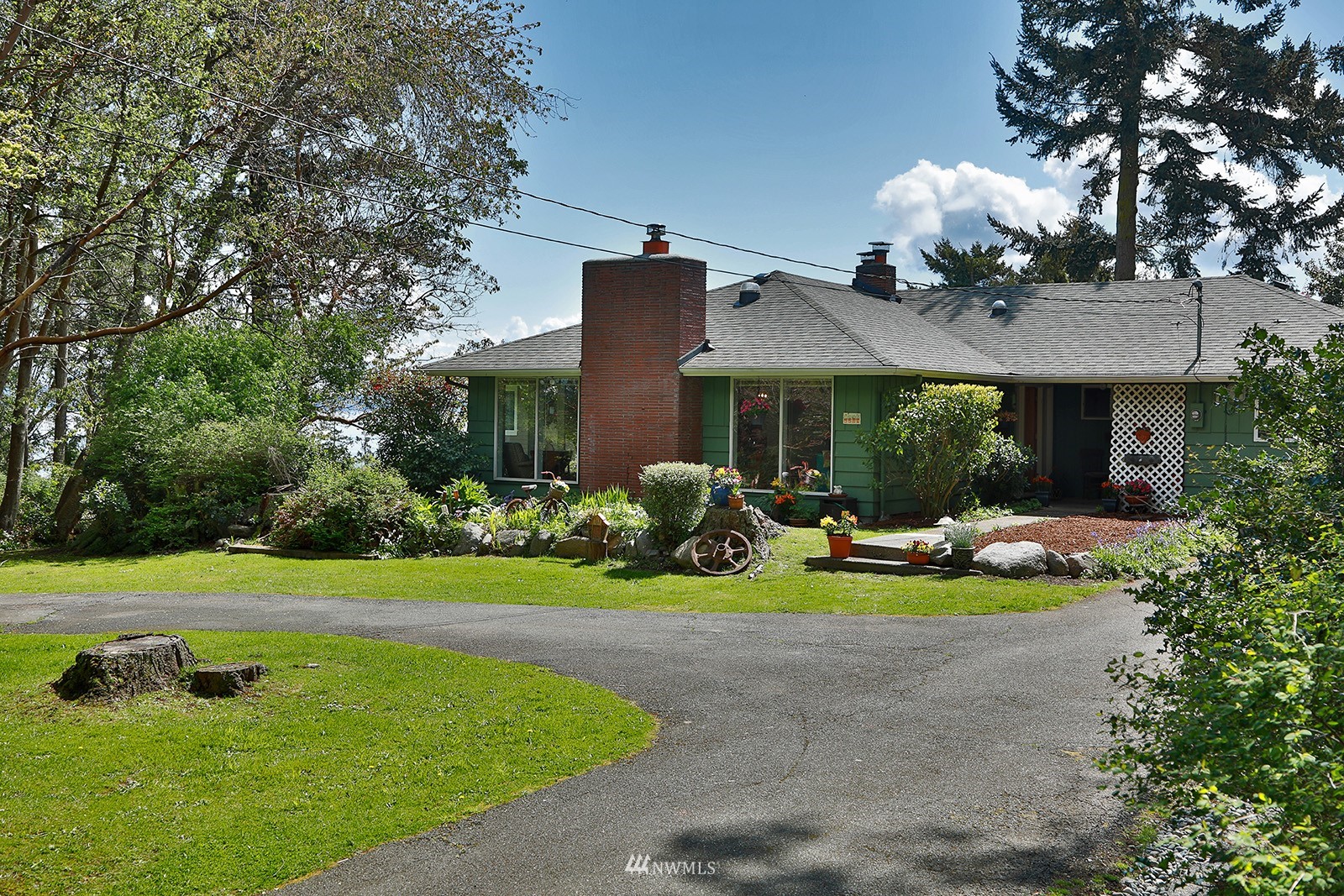 1294 Bonnie View Acres Road Oak Harbor, WA 98277 - Photo 26 of 39 a front view of a house with garden and porch