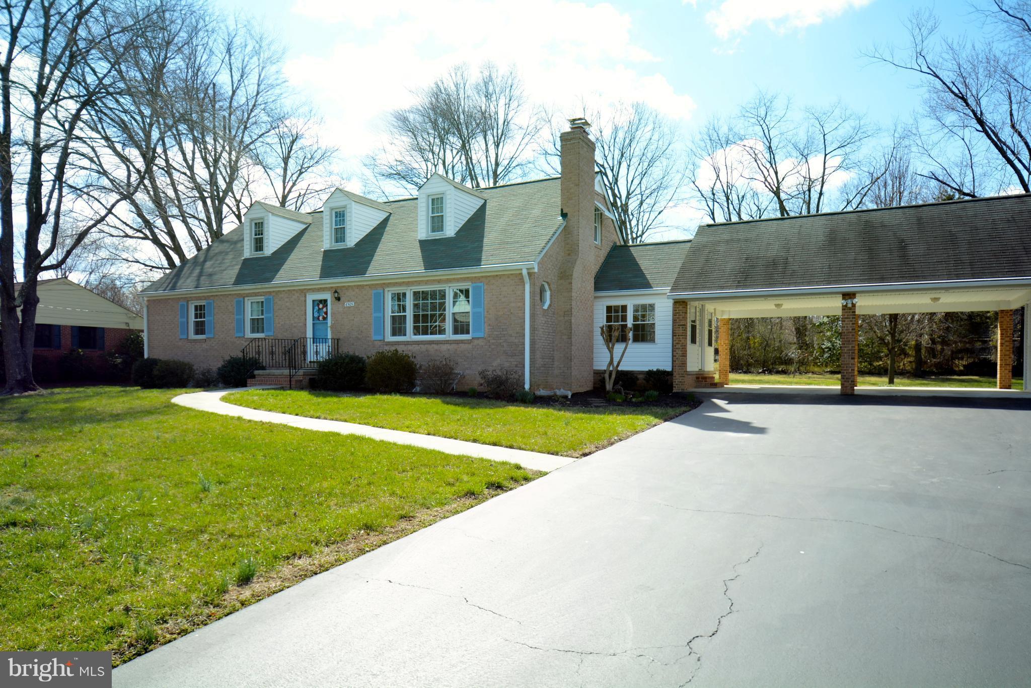 6505 Kalmia Street Springfield, VA 22150 - Photo 1 of 30 a front view of a house with a yard and potted plants
