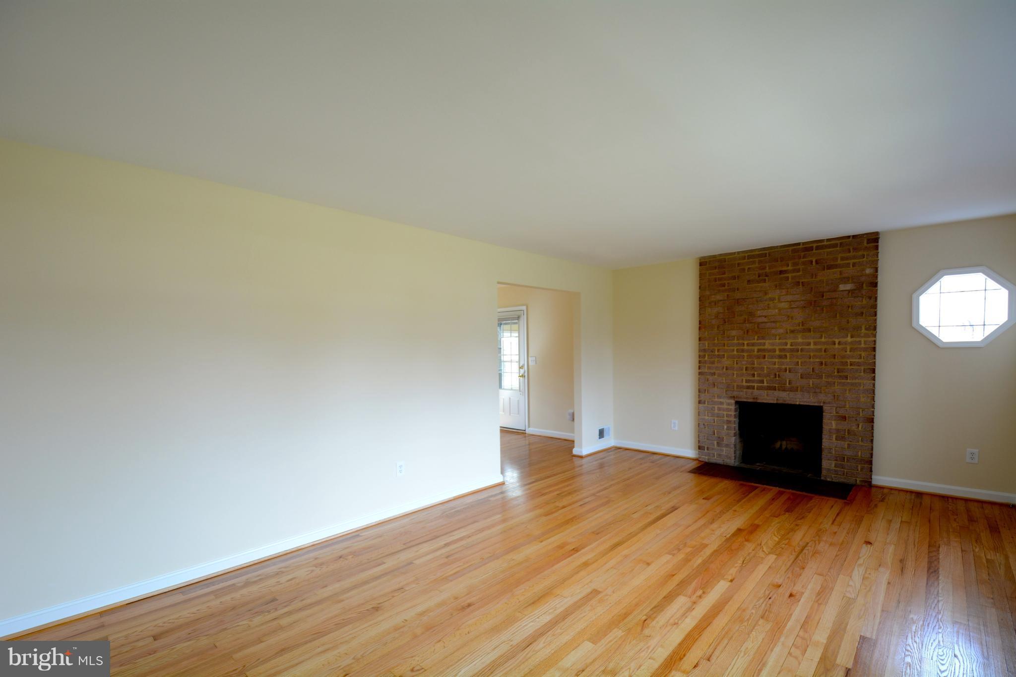 6505 Kalmia Street Springfield, VA 22150 - Photo 13 of 30 wooden floor fireplace and natural light in room