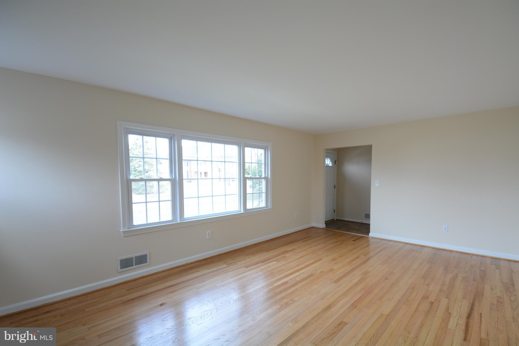 6505 Kalmia Street Springfield, VA 22150 - Photo 14 of 30 an empty room with wooden floor and windows