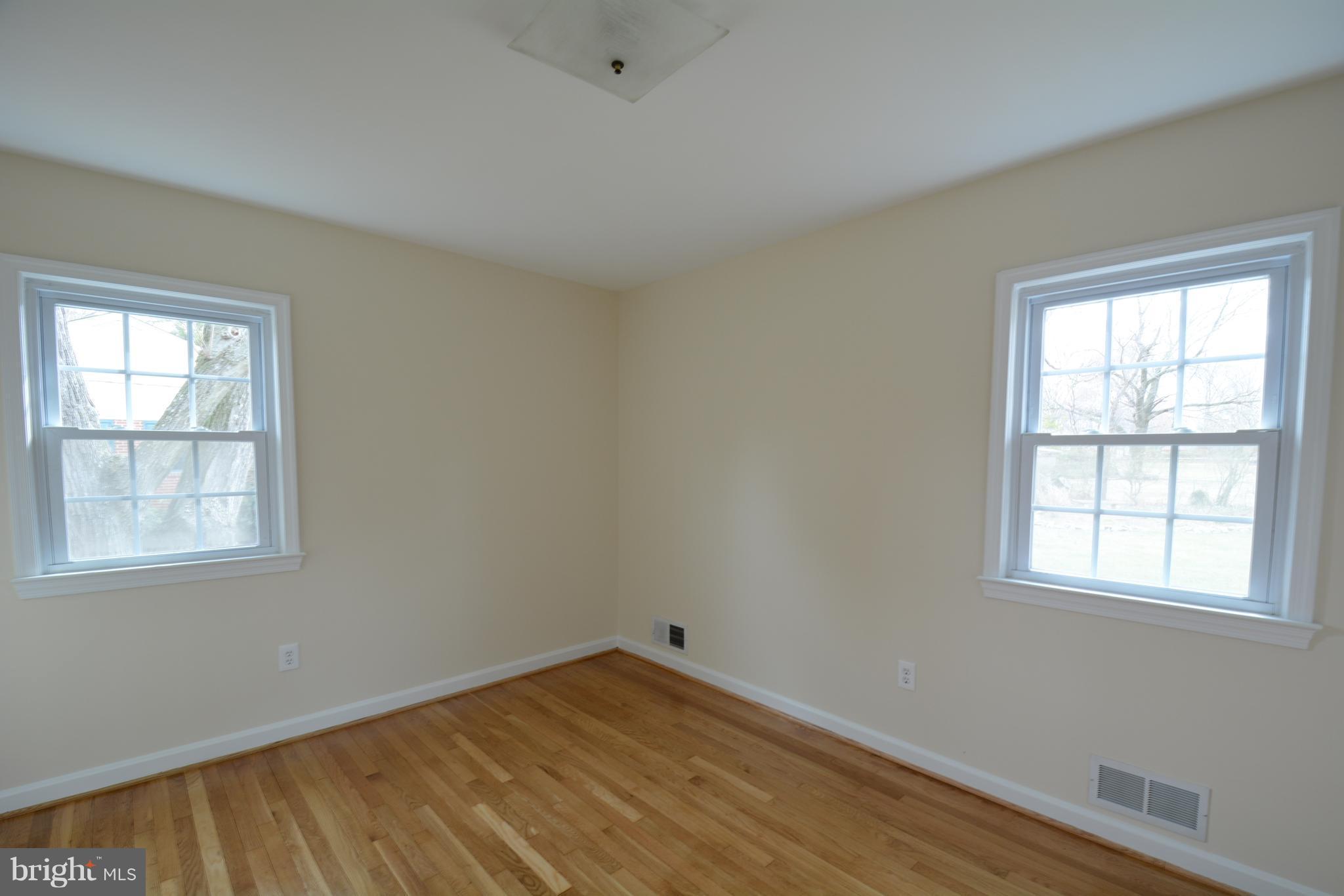 6505 Kalmia Street Springfield, VA 22150 - Photo 18 of 30 an empty room with wooden floor and windows
