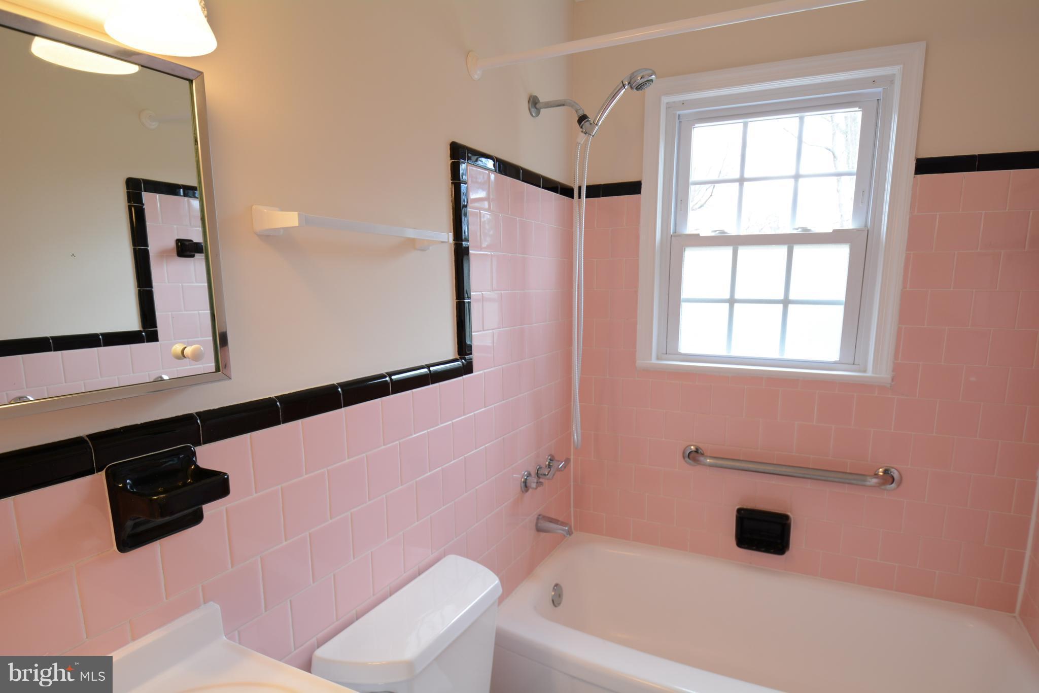 6505 Kalmia Street Springfield, VA 22150 - Photo 21 of 30 a bathroom with a bathtub shower sink vanity and toilet