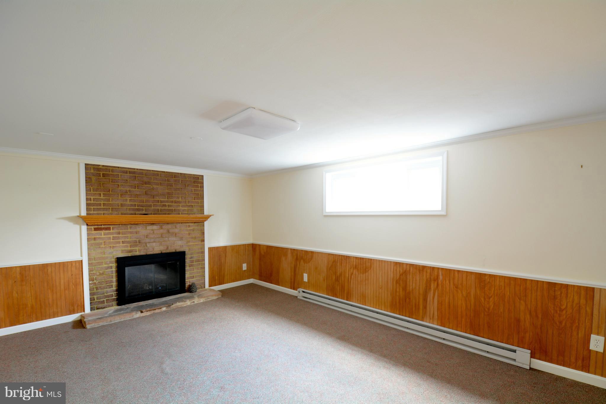 6505 Kalmia Street Springfield, VA 22150 - Photo 24 of 30 an empty room with a fireplace and a window