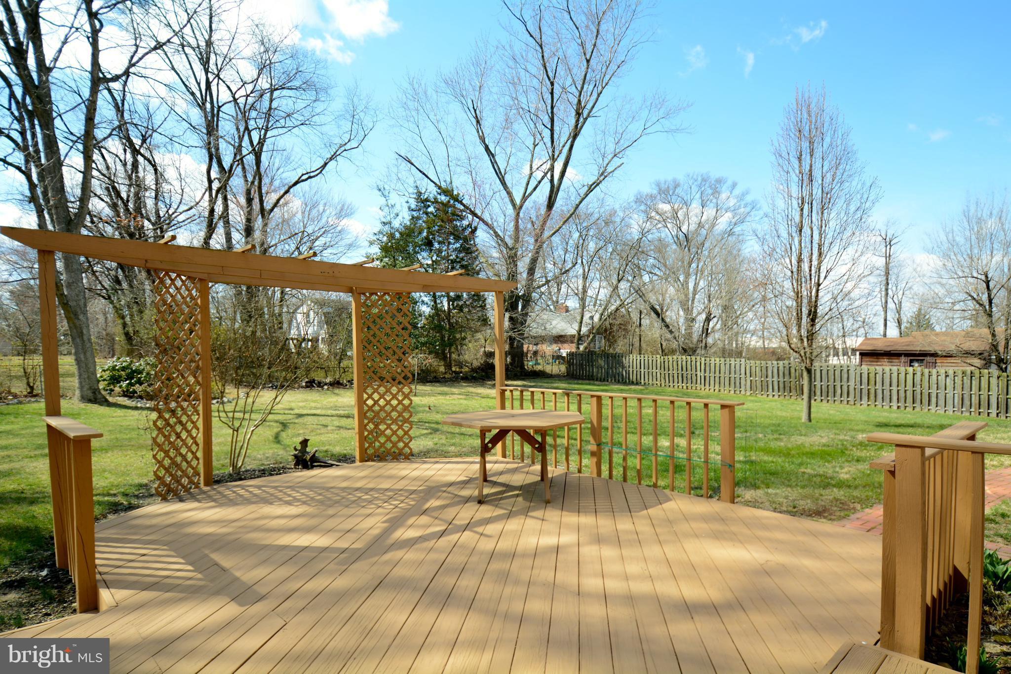 6505 Kalmia Street Springfield, VA 22150 - Photo 27 of 30 a view of a park with large trees and a wooden fence