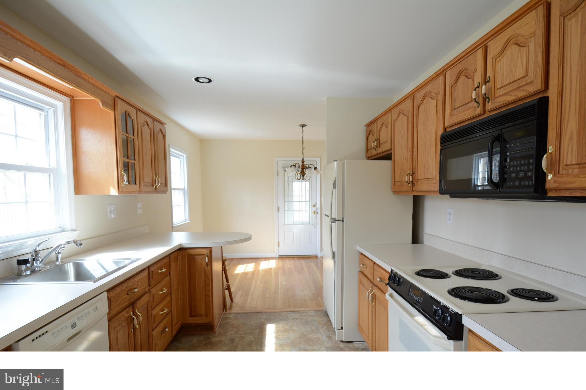 6505 Kalmia Street Springfield, VA 22150 - Photo 5 of 30 a kitchen with a stove a sink and a microwave