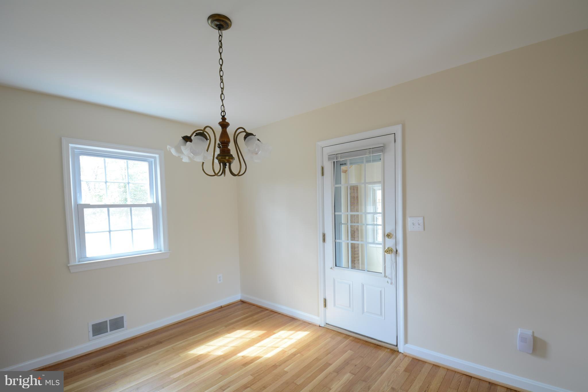 6505 Kalmia Street Springfield, VA 22150 - Photo 7 of 30 a view of an empty room with window and wooden floor