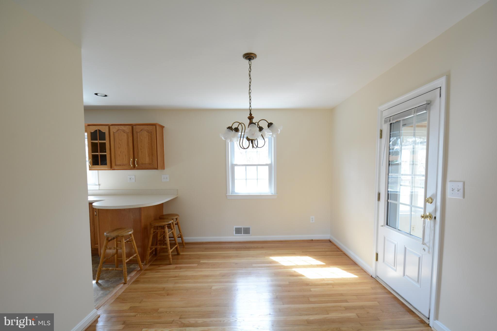 6505 Kalmia Street Springfield, VA 22150 - Photo 8 of 30 a view of an empty room with window and wooden floor