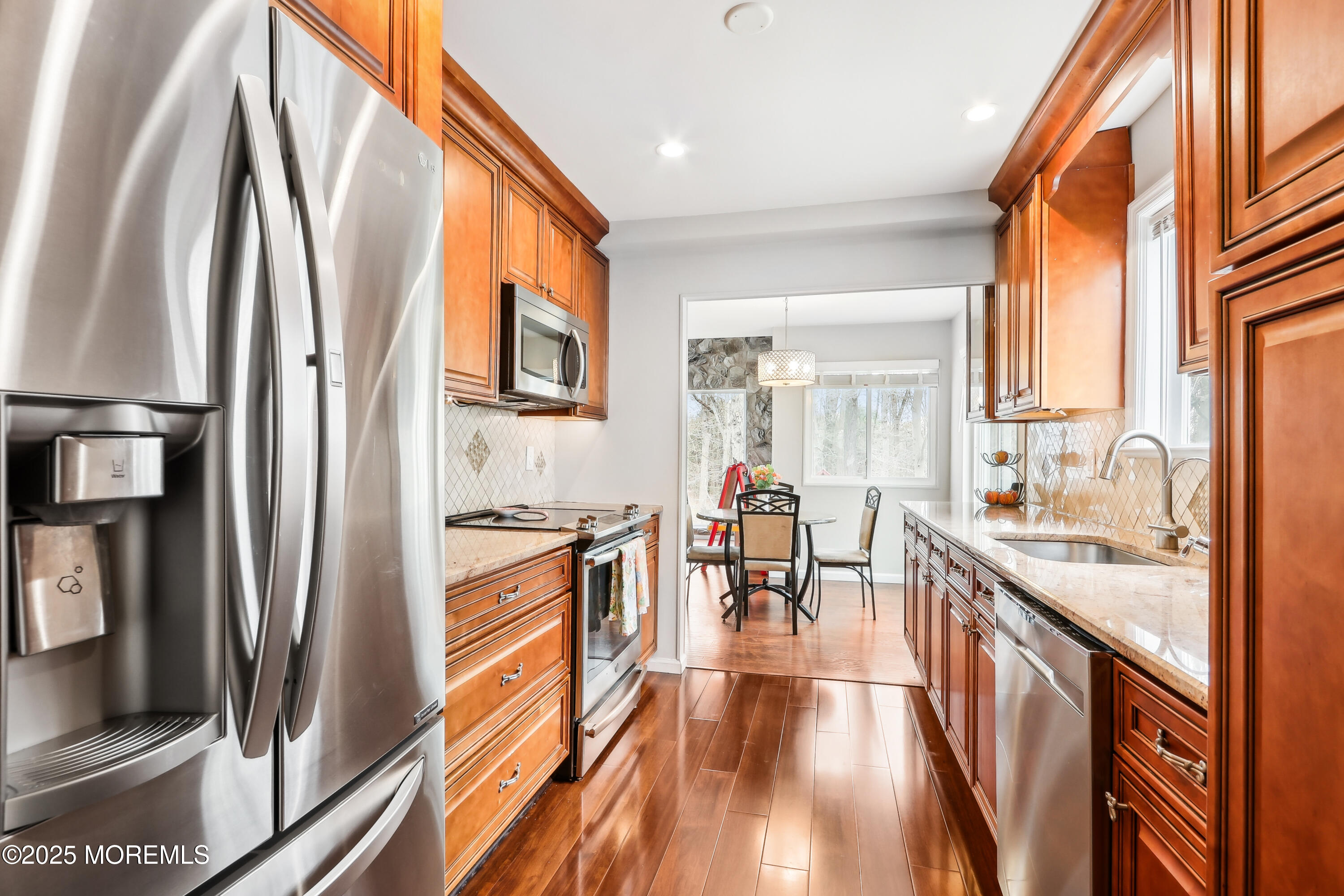 15 Pemberton Drive Matawan, NJ 07747 - Photo 17 of 67 a kitchen with stainless steel appliances granite countertop a refrigerator a stove top oven a sink and dishwasher