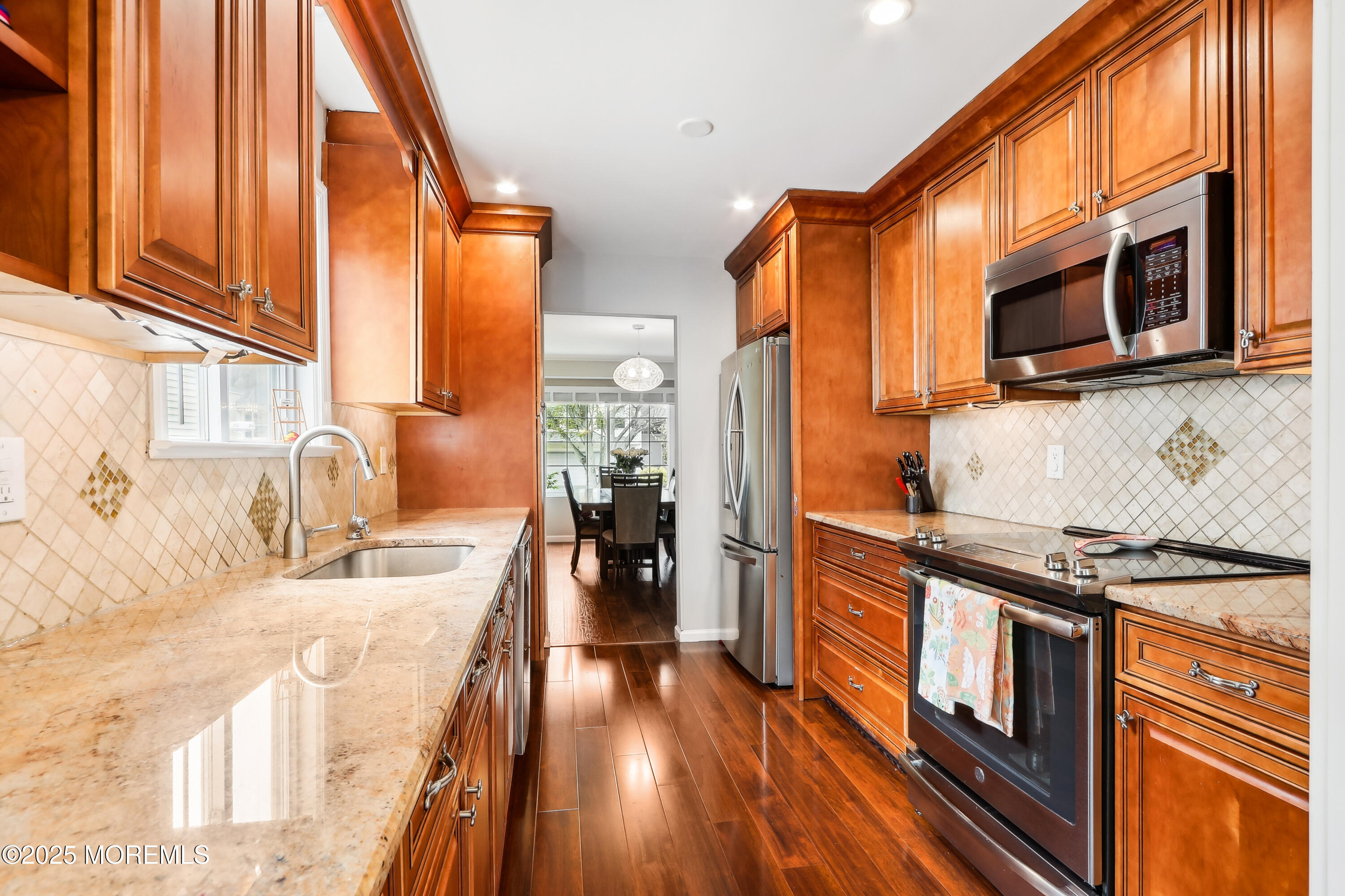 15 Pemberton Drive Matawan, NJ 07747 - Photo 19 of 67 a kitchen with stainless steel appliances a stove a sink and a refrigerator