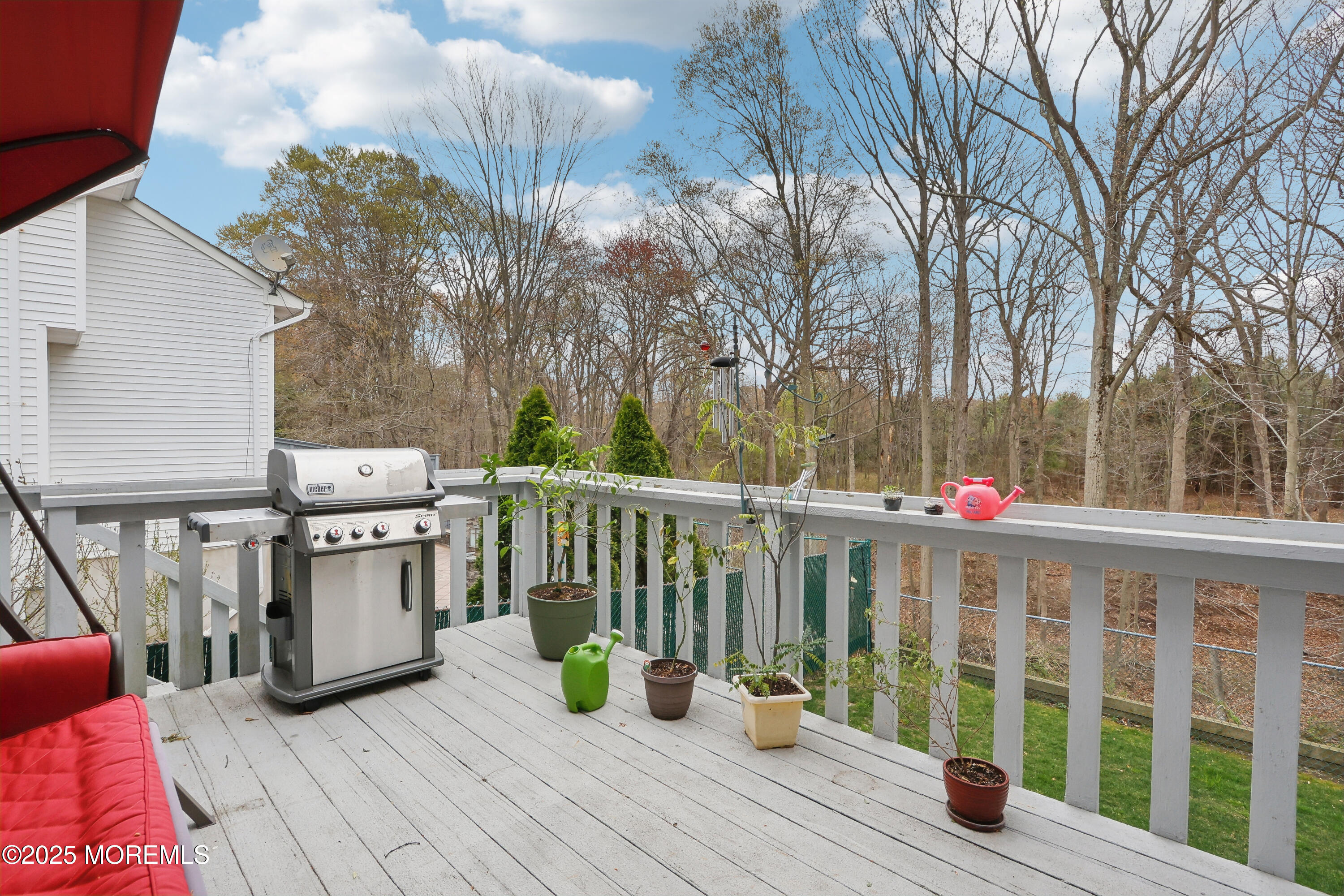15 Pemberton Drive Matawan, NJ 07747 - Photo 38 of 67 a view of a deck with table and chairs and wooden floor
