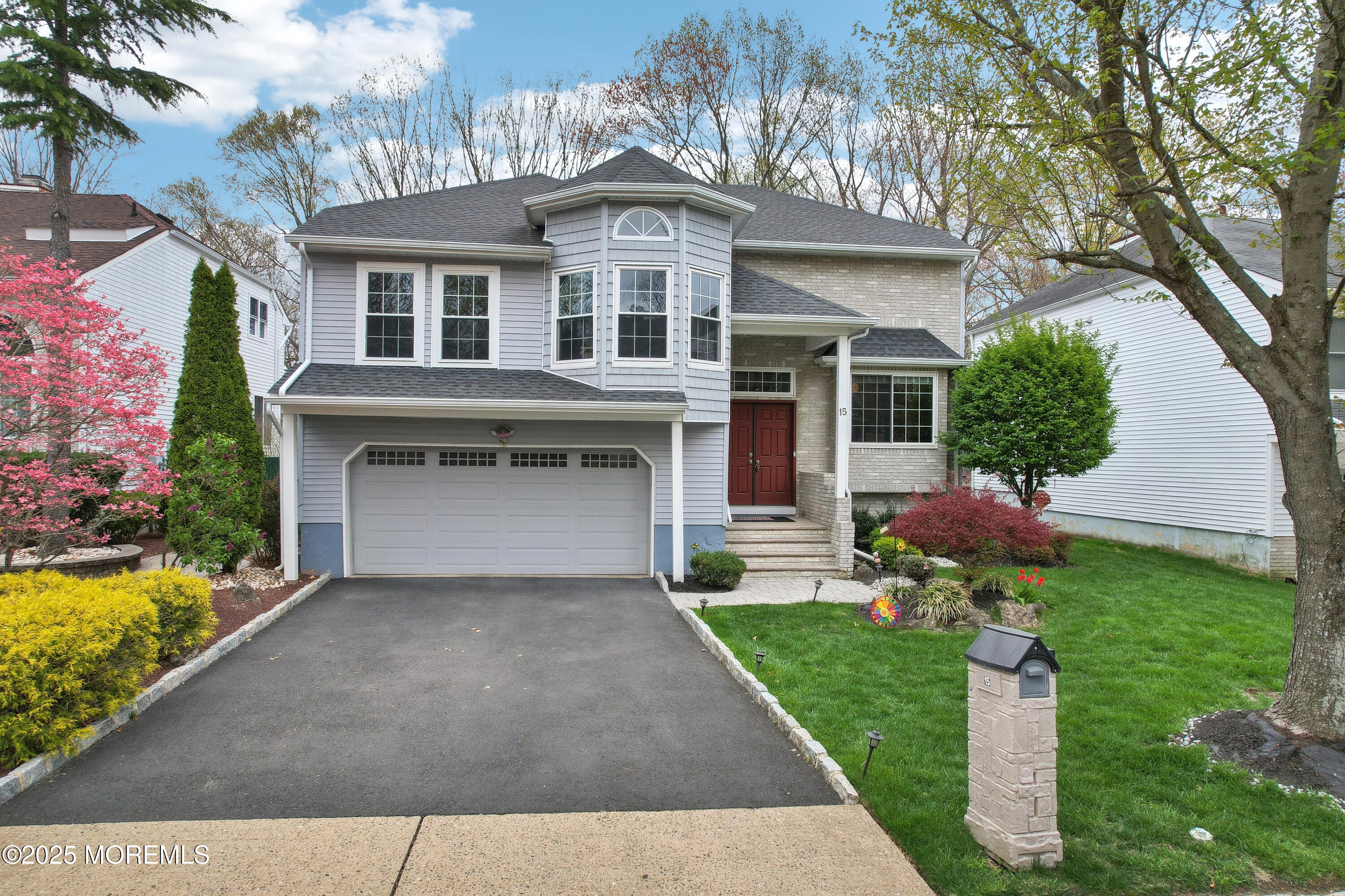 15 Pemberton Drive Matawan, NJ 07747 - Photo 46 of 67 a front view of a house with a garden and yard