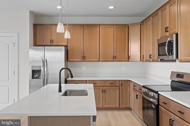 a kitchen with a sink cabinets and appliances