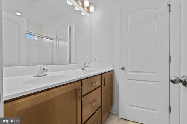 a bathroom with a granite countertop toilet and a sink
