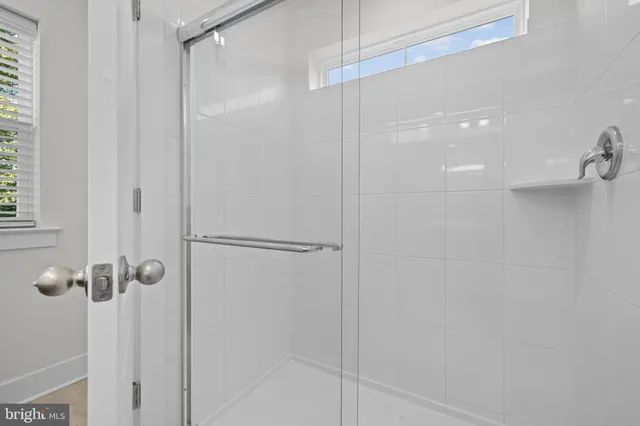 a bathroom with a glass shower door
