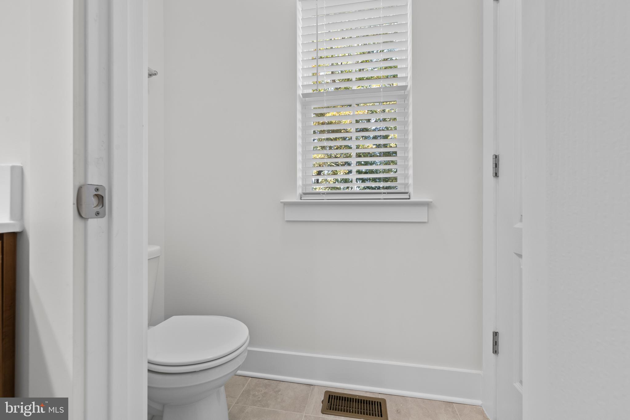 148 West Baltimore Street Taneytown, MD 21787 - Photo 46 of 52 a bathroom with a granite countertop toilet and a sink