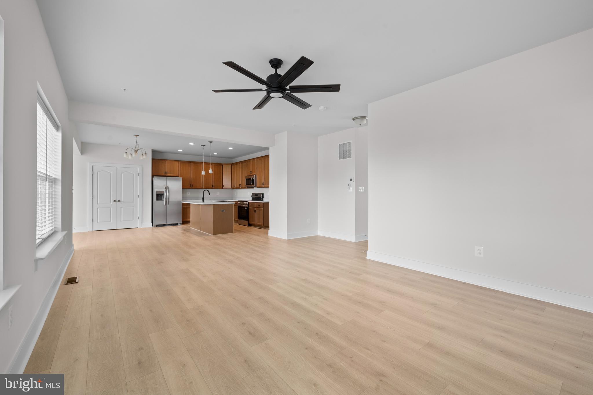 148 West Baltimore Street Taneytown, MD 21787 - Photo 10 of 52 a view of a livingroom with a hardwood floor and a ceiling fan