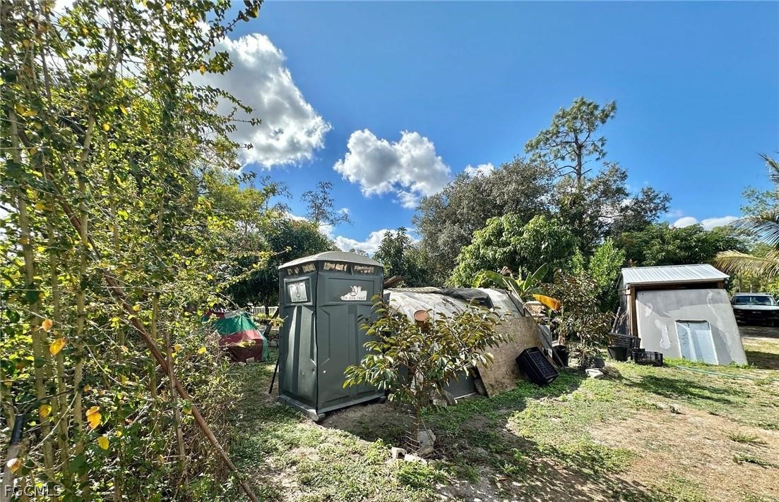 9320 Buckingham Road Fort Myers, FL 33905 - Photo 12 of 19 a view of a house with a yard and garden
