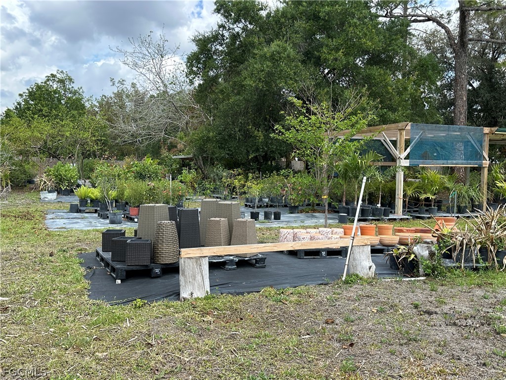 9320 Buckingham Road Fort Myers, FL 33905 - Photo 15 of 19 a view of swimming pool with lawn chairs and a fire pit