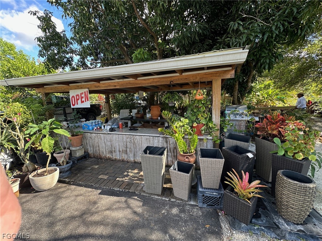 9320 Buckingham Road Fort Myers, FL 33905 - Photo 2 of 19 a view of a patio with table and chairs potted plants