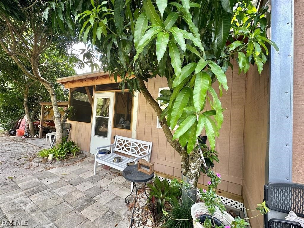 9320 Buckingham Road Fort Myers, FL 33905 - Photo 3 of 19 a view of a chair and table in the garden