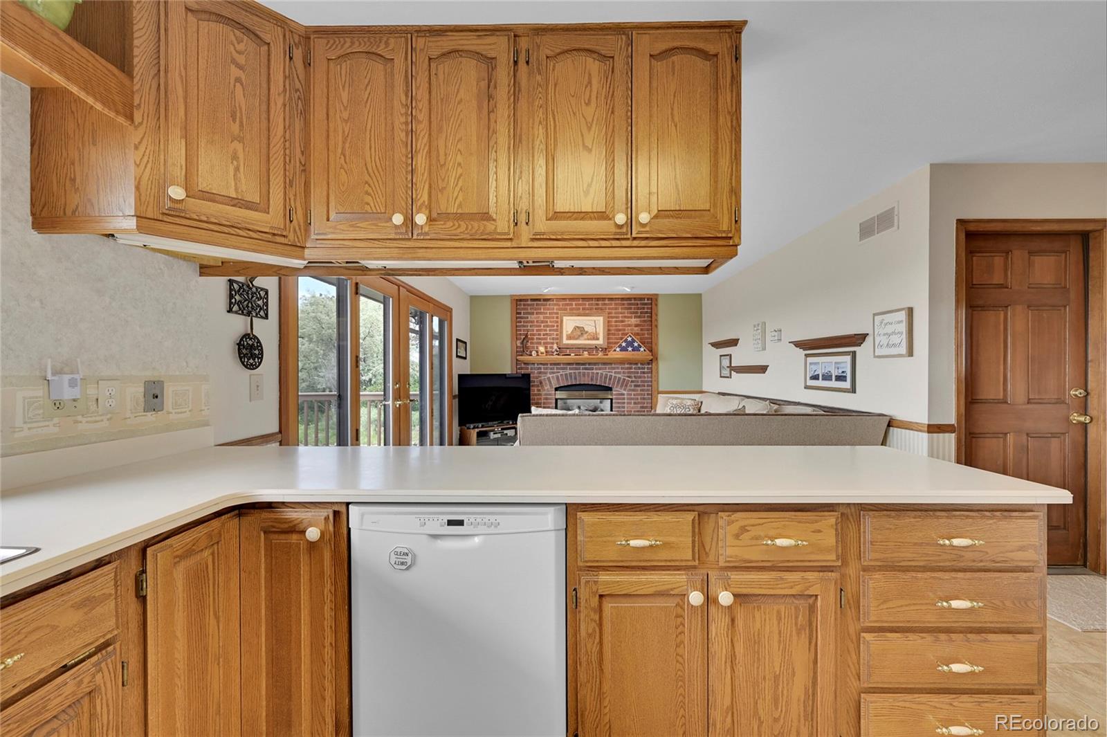 12377 West Louisiana Avenue Lakewood, CO 80228 - Photo 11 of 50 a kitchen with stainless steel appliances granite countertop a sink dishwasher and cabinets with wooden floor