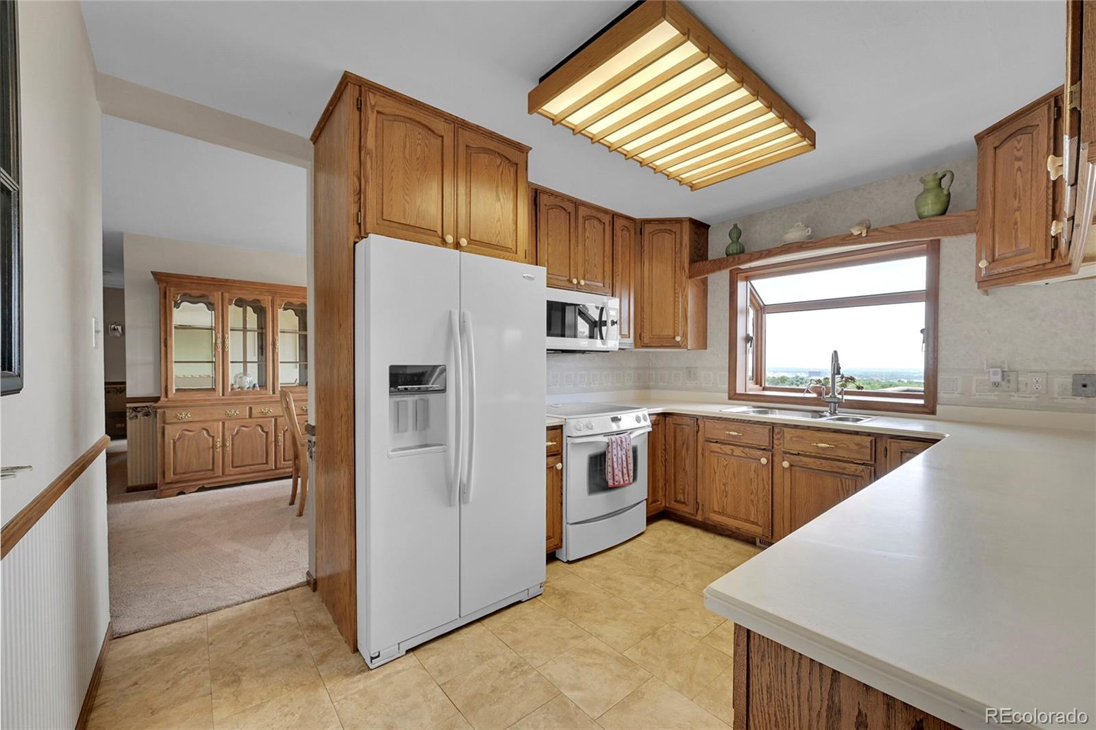 12377 West Louisiana Avenue Lakewood, CO 80228 - Photo 12 of 50 a kitchen with stainless steel appliances granite countertop a refrigerator a sink dishwasher stove and oven