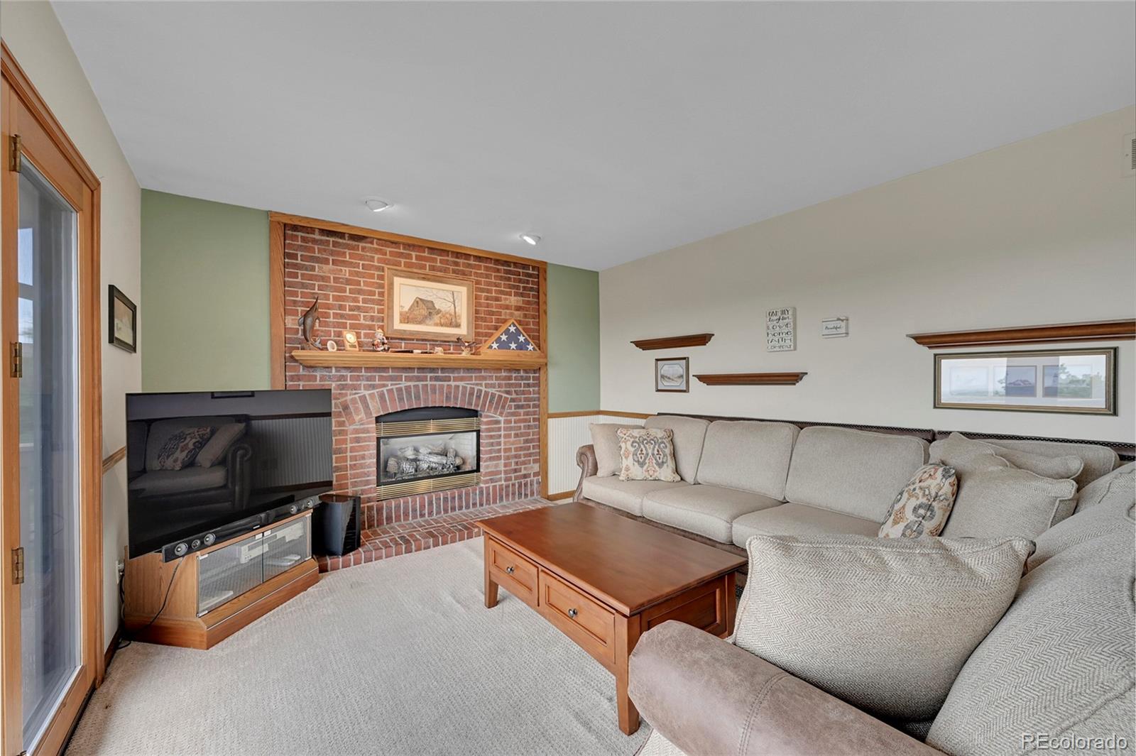 12377 West Louisiana Avenue Lakewood, CO 80228 - Photo 14 of 50 a living room with furniture and a fireplace