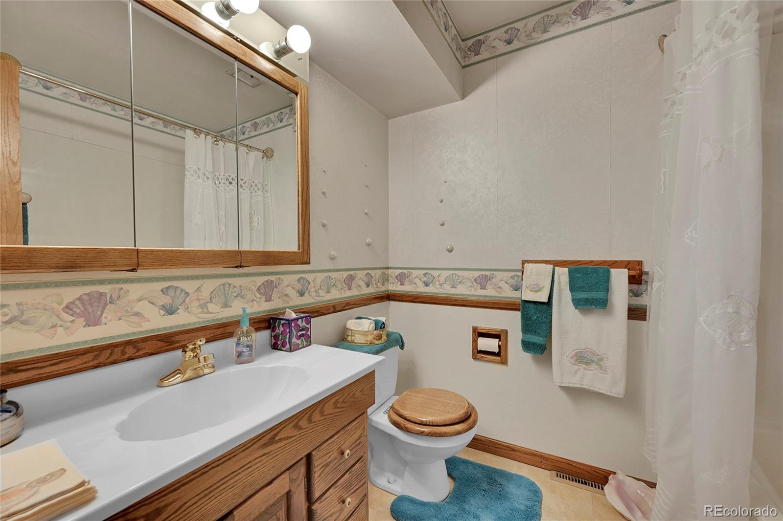 12377 West Louisiana Avenue Lakewood, CO 80228 - Photo 18 of 50 a bathroom with a sink and a toilet