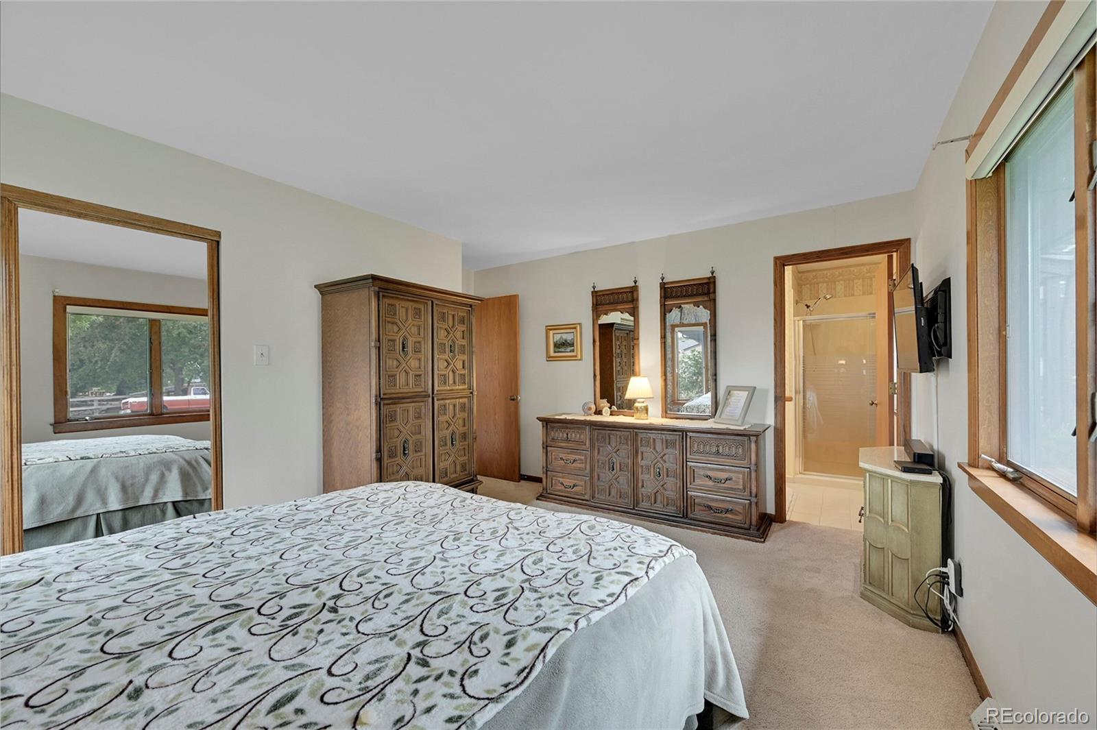 12377 West Louisiana Avenue Lakewood, CO 80228 - Photo 20 of 50 a bedroom with a large bed and dresser