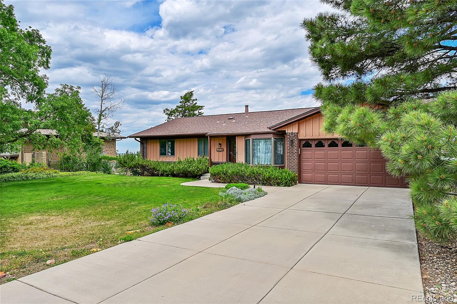 12377 West Louisiana Avenue Lakewood, CO 80228 - Photo 2 of 50 a front view of a house with a garden