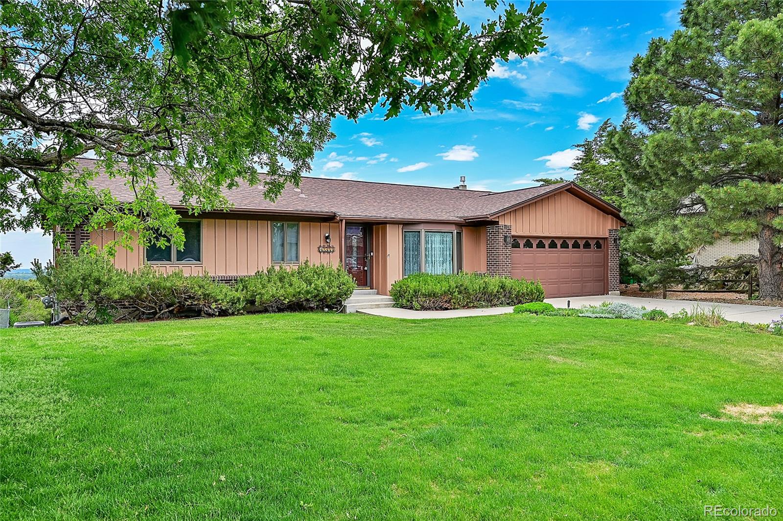 12377 West Louisiana Avenue Lakewood, CO 80228 - Photo 3 of 50 a front view of a house with a yard