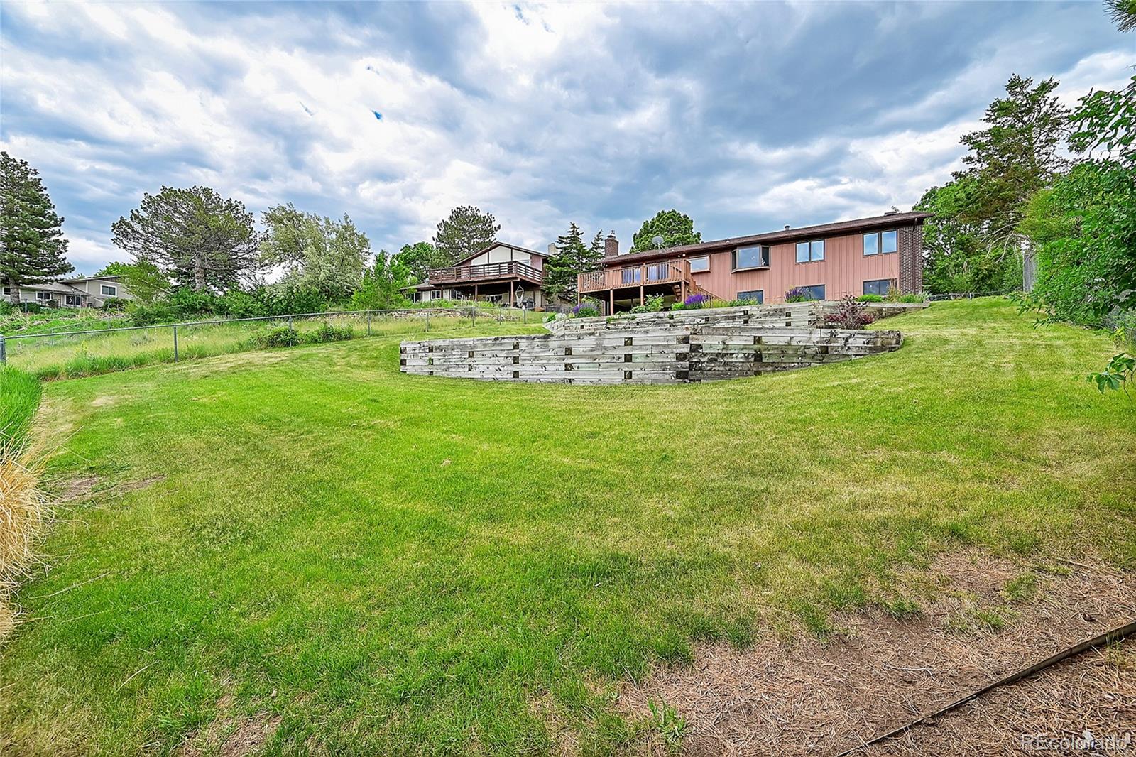 12377 West Louisiana Avenue Lakewood, CO 80228 - Photo 37 of 50 a view of a garden with a building in the background
