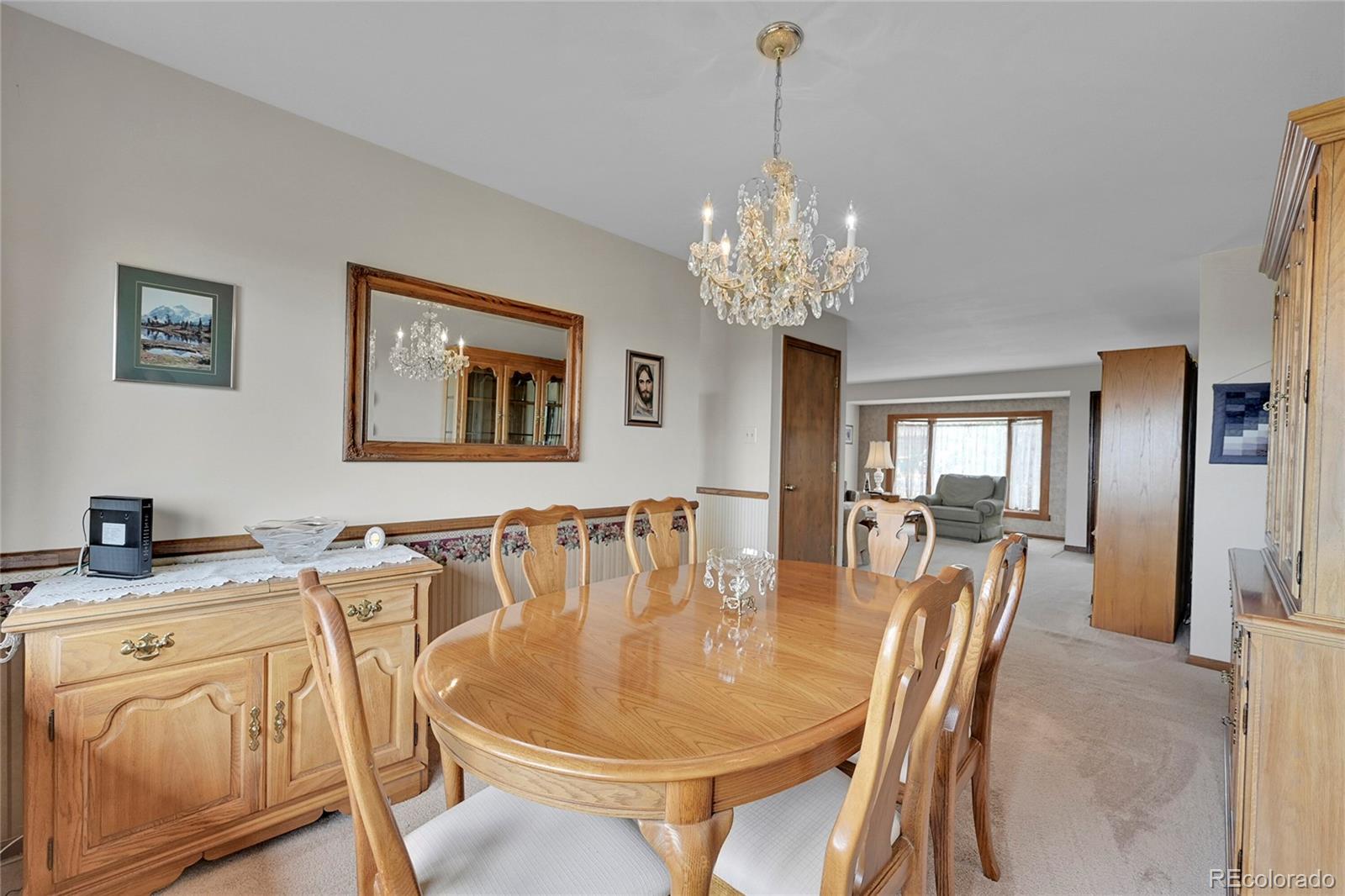 12377 West Louisiana Avenue Lakewood, CO 80228 - Photo 8 of 50 a dining room with furniture a chandelier and window